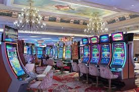 nslot99 live-dealer baccarat table with Thomas Cup match visible on secondary screen